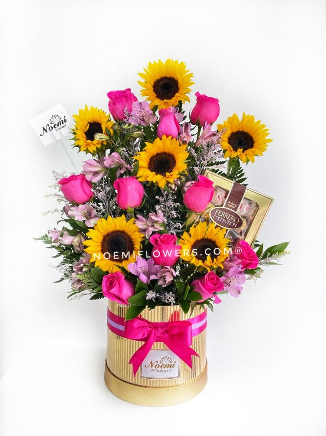 Dulce Sorpresa confeccionado de girasoles, rosas, astromelias, solidago y helechos acompañado de Ferrero Rocher collections - Floristería Noemi Flowers