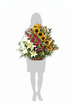 Canasta Imperial confeccionada con girasoles, rosas, lirios y follaje variado - Floristería Noemi Flowers. 