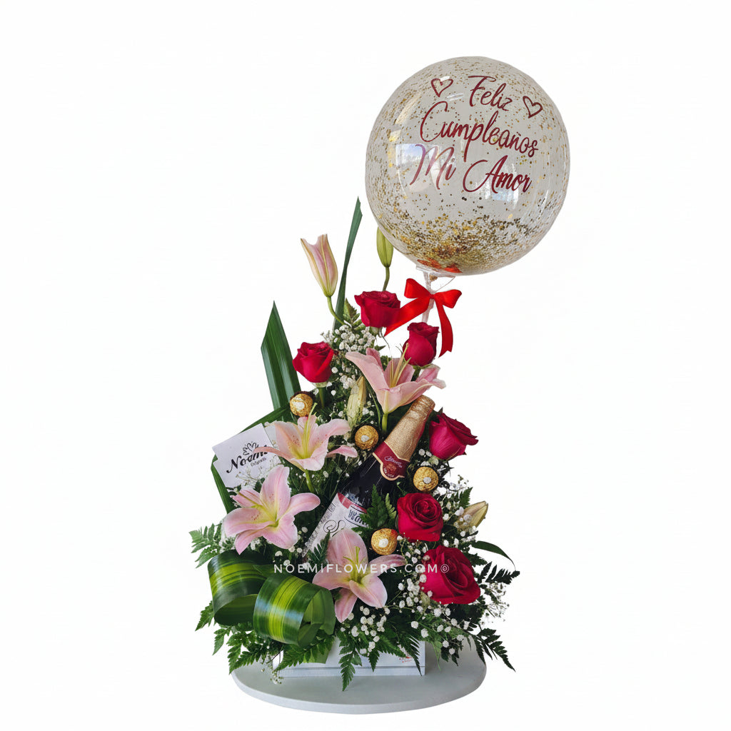 Arreglo Floral con rosas rojas lirios bombones de chocolates y globo burbuja personalizado - Floristería Noemi Flowers