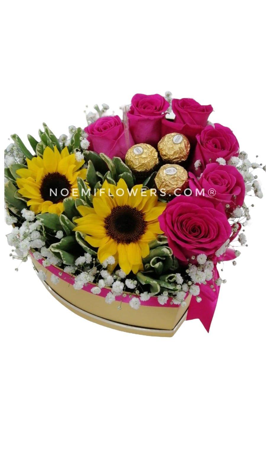 Caja con rosas fucsia girasoles y bombones - Floristería Noemi Flowers
